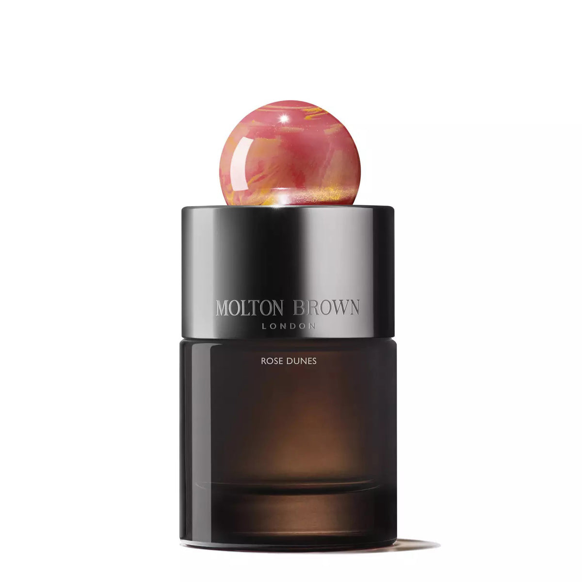 A black and brown gradient glass bottle of MOLTON BROWN&#39;s &quot;Rose Dunes Eau De Parfum,&quot; topped with a round, marble-like cap featuring pink and gold swirls. The brand name &quot;MOLTON BROWN LONDON&quot; and the perfume name &quot;Rose Dunes&quot; are printed in white on the bottle, hinting at notes of velvety rose.