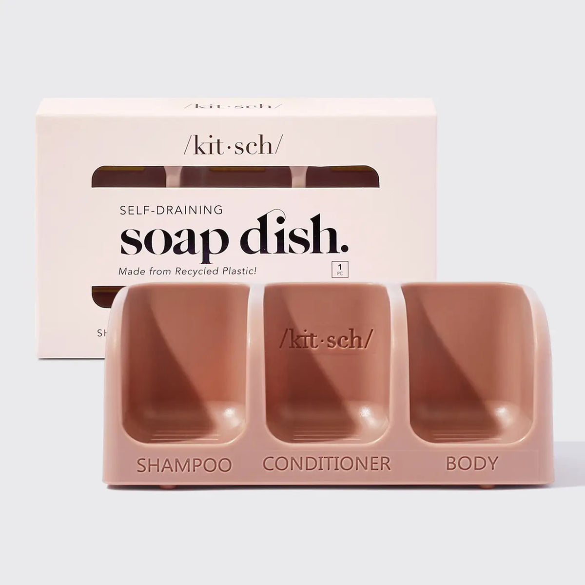 The KITSCH Self Draining Soap Dish for 3 Bars features labeled compartments for shampoo, conditioner, and body bars. Its eco-friendly, self-draining design keeps bars dry, all displayed against a plain light background.