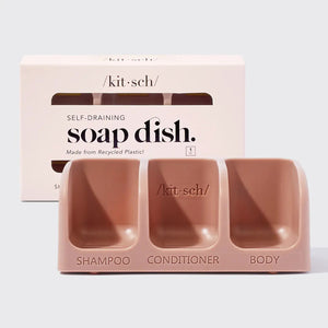 The KITSCH Self Draining Soap Dish for 3 Bars features labeled compartments for shampoo, conditioner, and body bars. Its eco-friendly, self-draining design keeps bars dry, all displayed against a plain light background.