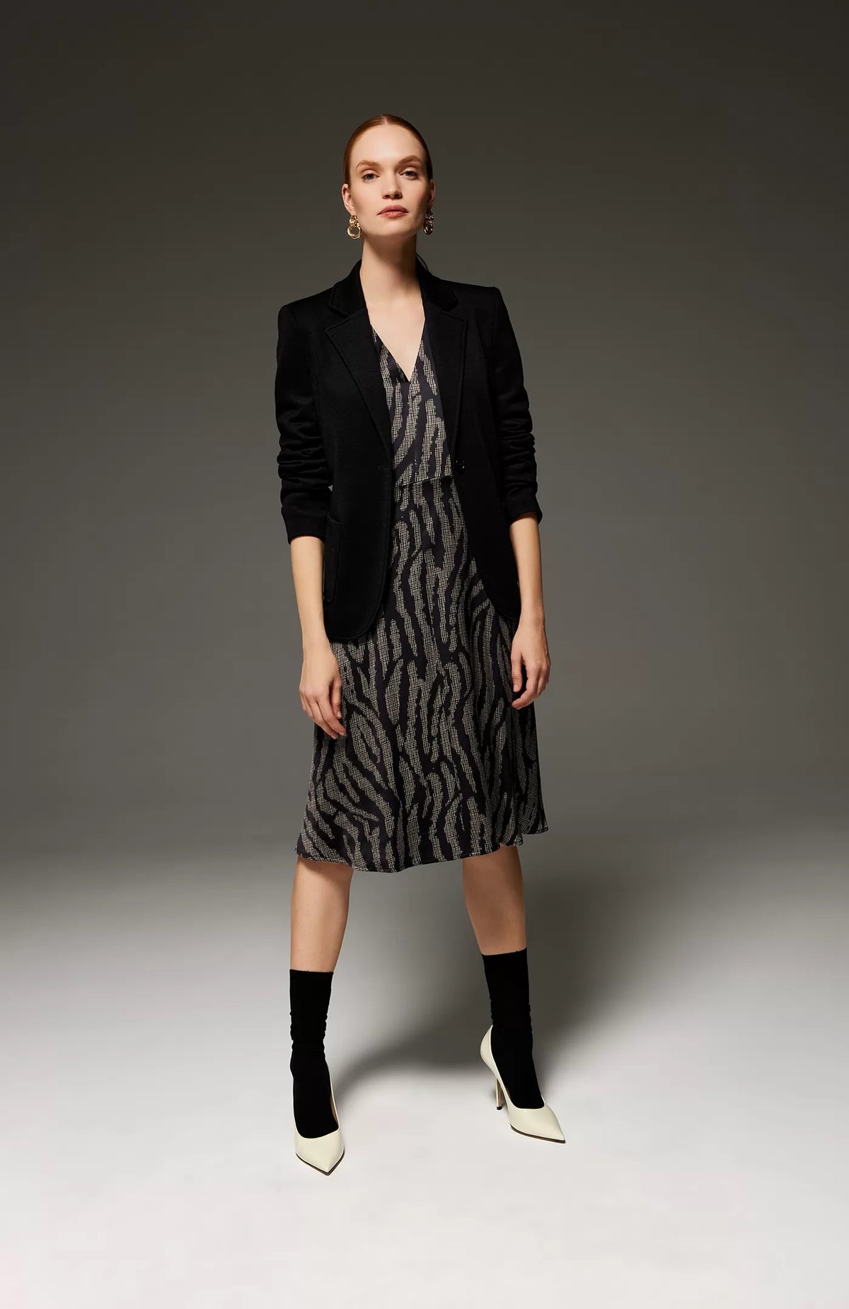 The SEVENTY - SINGLE BREASTED KNIT JACKET by the brand SEVENTY is a tailored women&#39;s jacket in black, featuring classic lapels, a single-button closure, and two front pockets. It has a sleek, fitted design and a minimalist, professional appearance. The interior is lined with the &quot;SEVENTY&quot; label visible inside.