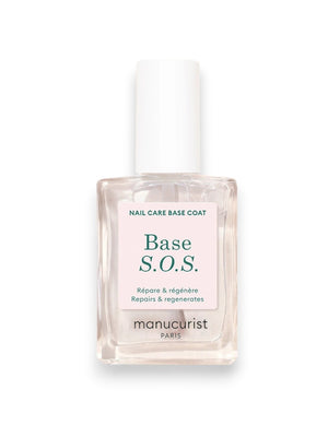 A close-up of the MANUCURIST - S.O.S. NAIL STRENGTHENER BASE COAT by MANUCURIST INC being applied, with text highlighting AHA for exfoliation, Vitamin C for protection, Vitamin B5 for hydration, and Hexanol for repair. Soft pink leaf background.