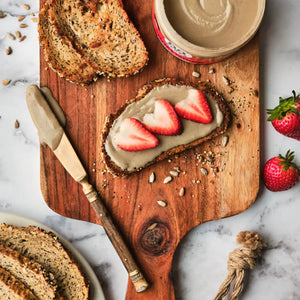 A 14 oz jar of 88 ACRES- SUNFLOWER SEED BUTTER JAR by 88 ACRES, featuring a green and red label that highlights its nut-free status, USDA organic certification, and 5g of protein per serving. This sunflower seed butter is a pantry staple, crafted with care and lightly sweetened with Vermont maple sugar.