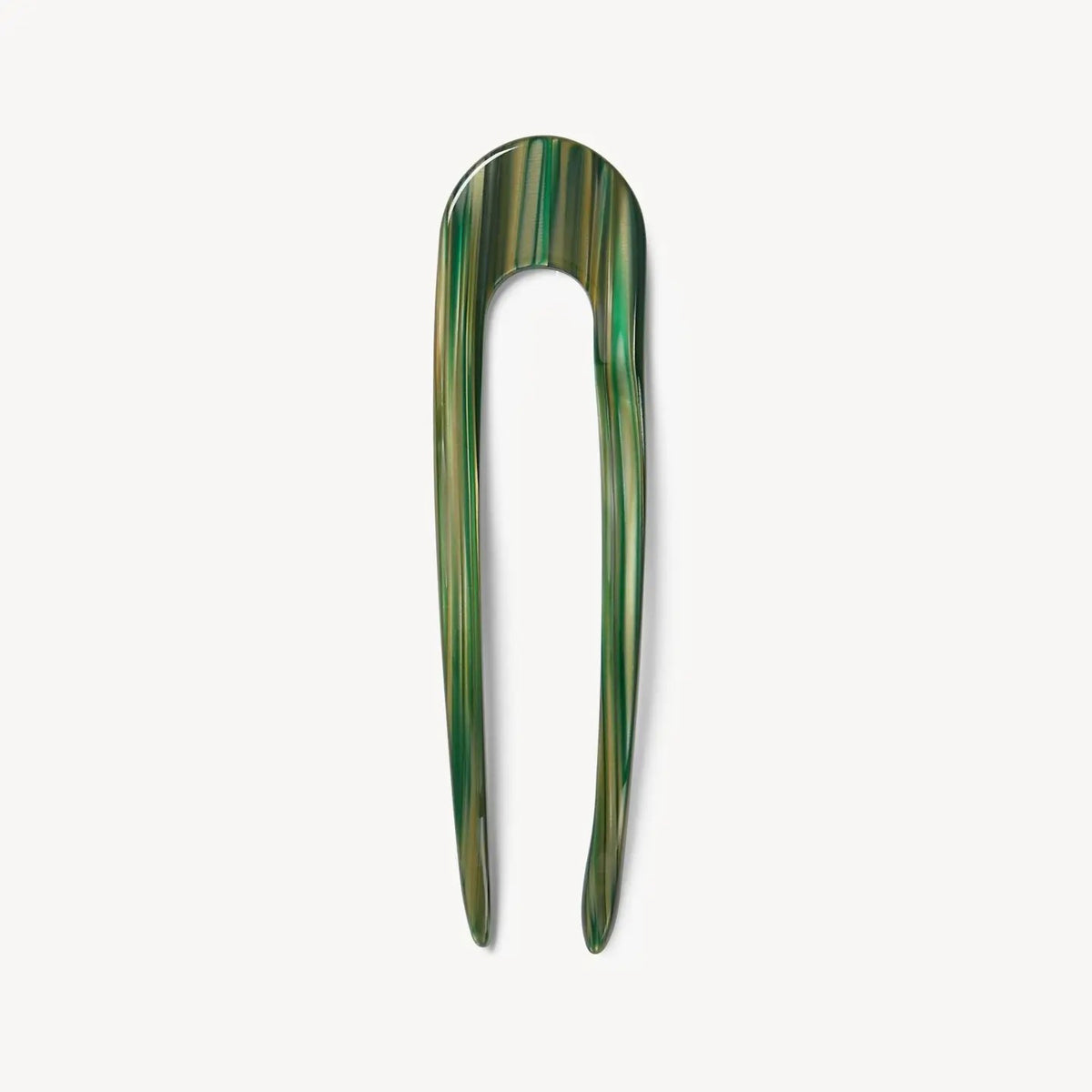 The MACHETE French Hair Pin in Meadow is a green marbled, handcrafted accessory with two long prongs and a rounded top, shown against a plain white background.