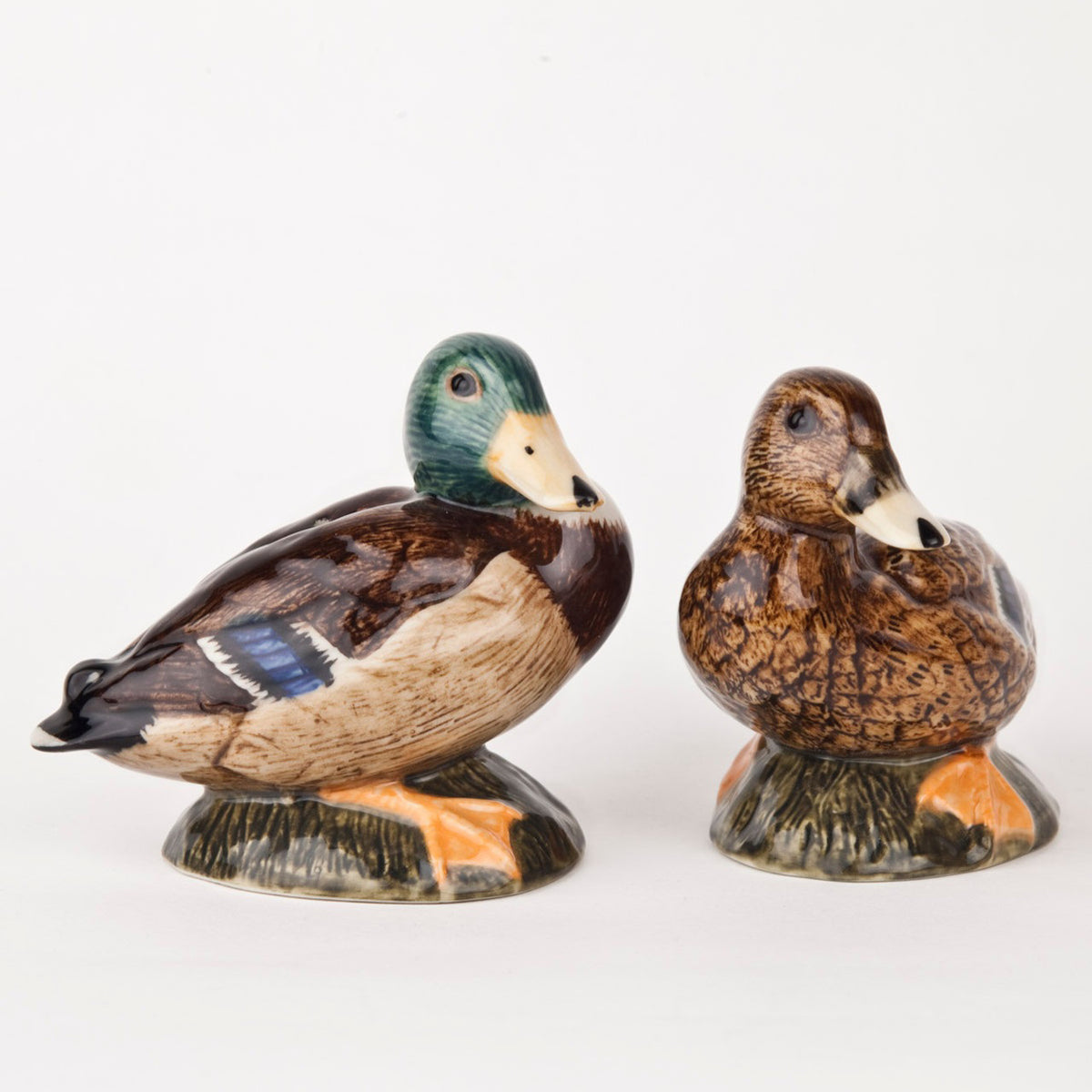 The QUAIL DESIGNS QUAIL CERAMICS Mallard Salt and Pepper Set features two handpainted shakers: one with a green head and brown chest, the other in mottled brown tones. Both face forward and are dishwasher safe for easy cleaning.