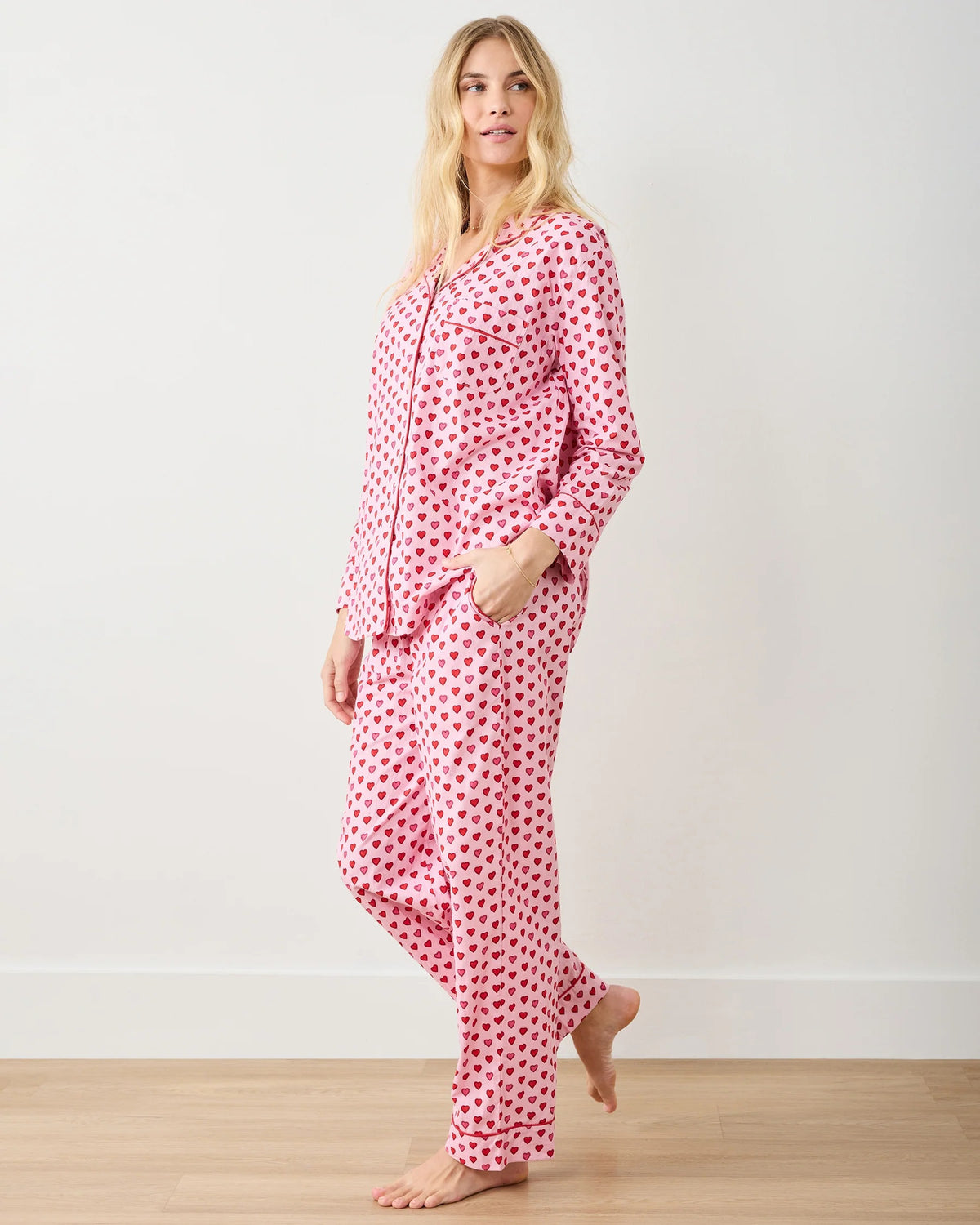 A seamless pattern of red and pink hearts arranged in neat rows on a light pink background, featured on the PRINTFRESH - MINI CANDY HEARTS LONG PAJAMA SET by PRINTFRESH, perfect for cozy Valentine's pajamas.