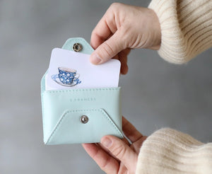 A hand holds the E. FRANCES - E. FRANNIE PACK, SEAGLASS wallet and a "THANKS! You're the best!" Little Note from E. FRANCES PAPER as a joyful gift, with @efrancespaper shown in the corner.