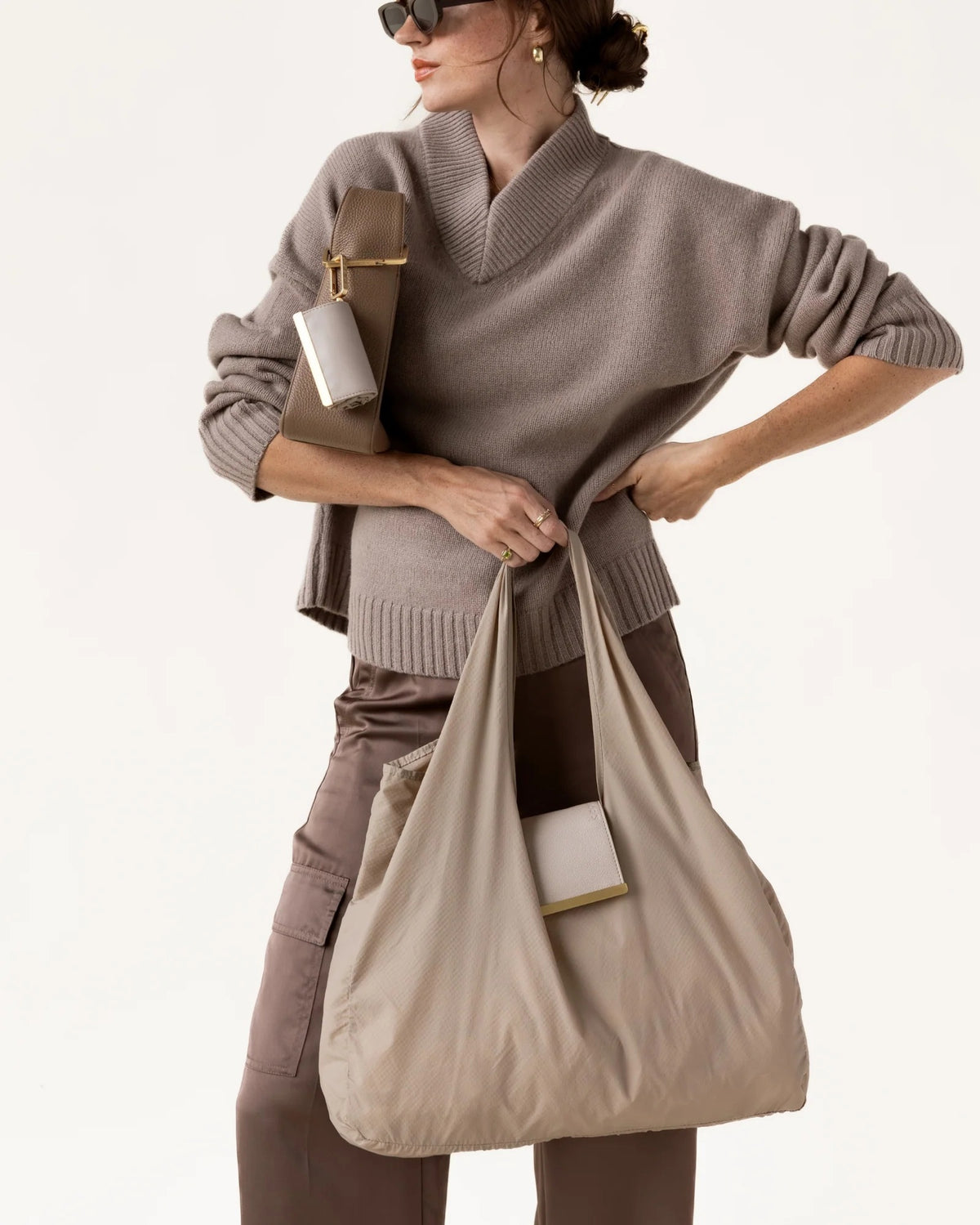 The KEOTE - KEYCHAIN TOTE IN STONE by KEOTE is a beige, lightweight, crinkled tote laid flat, with a matching rectangular pouch and keychain attachment shown above for easy storage of the reusable bag.
