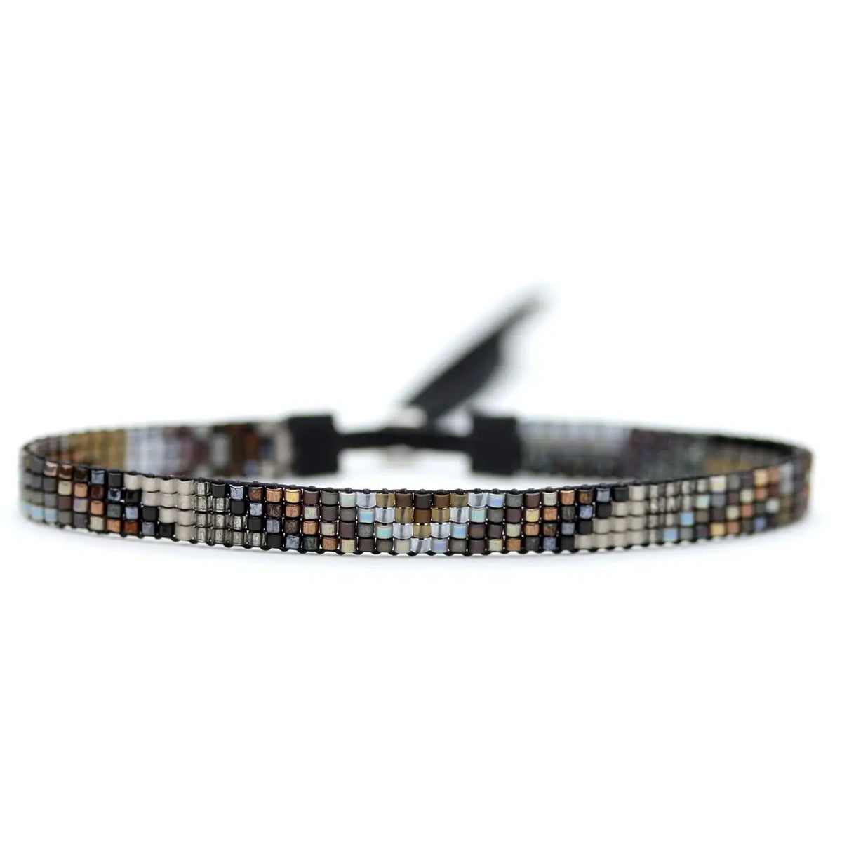 The image features a close-up of the JULIE ROFMAN - NIGHT BRACELET by JULIE ROFMAN JEWELRY. This handwoven beaded bracelet displays a geometric mosaic pattern in shades of brown, gray, and black. The small square beads form an intricate design, enhanced by a sterling silver clasp against a white background.
