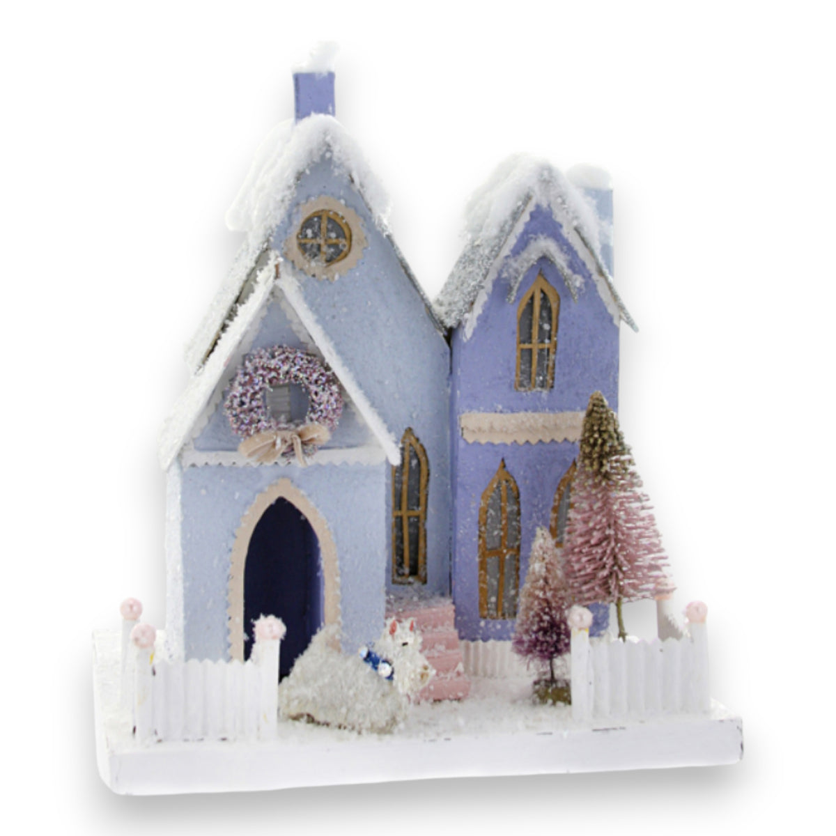 The BLUE BUNGALOW HOLIDAY HOUSE by CODY FOSTER features a pastel blue exterior, snowy roof, white picket fence, wreath, and pastel bottlebrush trees on a snowy base—an ideal gift for design lovers or collectors.