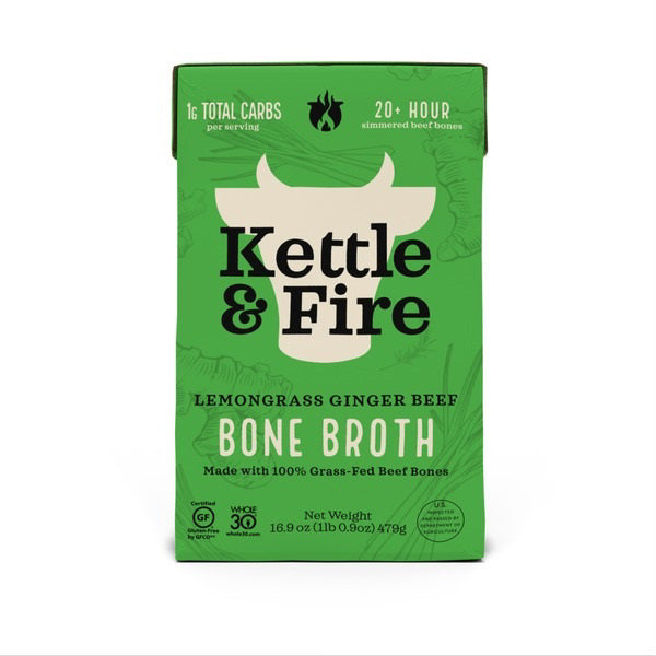 A green box of KETTLE &amp; FIRE - LEMONGRASS GINGER BONE BROTH. The packaging notes it has 1g total carbs per serving, is simmered over 20+ hours, non-GMO, gluten-free, Whole30 approved, and made with 100% grass-fed beef bones. Net weight 16.9 oz (1 lb 0.9 oz) 479g.
