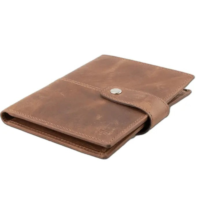 GARZINI RFID-blocking leather passport holder with AirTag compartment in brown, featuring a strap and snap button closure on a white background. The holder has a slightly worn, vintage look.