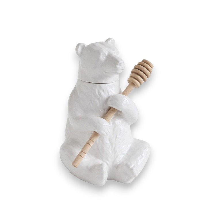 Against a plain background sits the CERAMIC BEAR HONEY HOLDER by CREATIVE COOP, a detailed ceramic jar featuring intricately crafted fur textures and accompanied by a bamboo honey dipper.