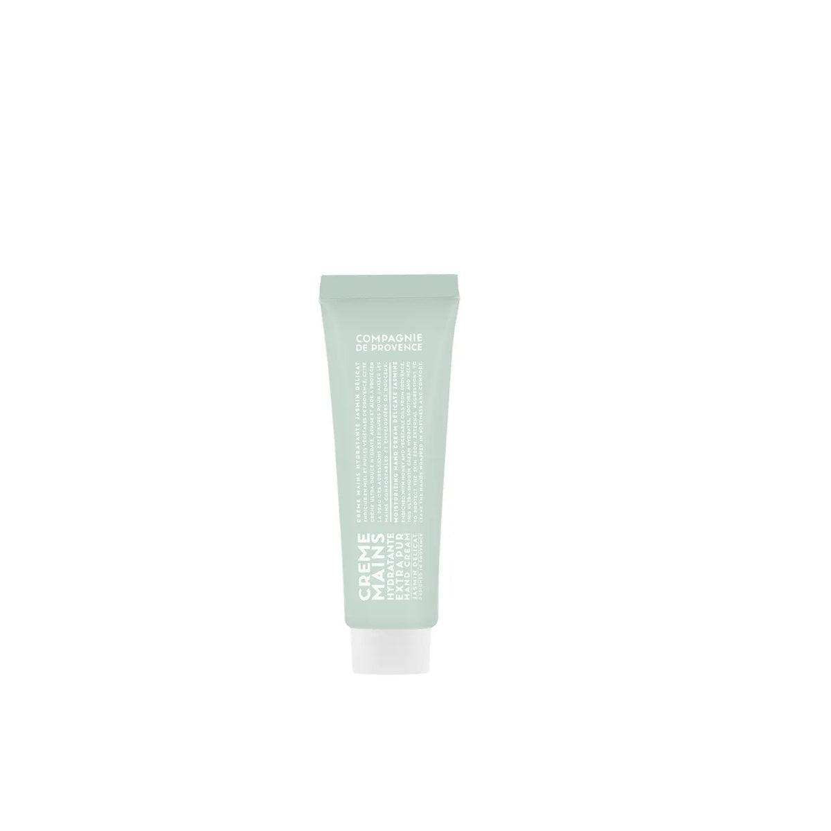 A light green tube of CIE LUXE BRANDS’ COMPAGNIE DE PROVENCE Travel Hand Cream Soft Jasmine 1oz, with white text and a white cap, enriched with botanical oils, stands upright on a plain white background.
