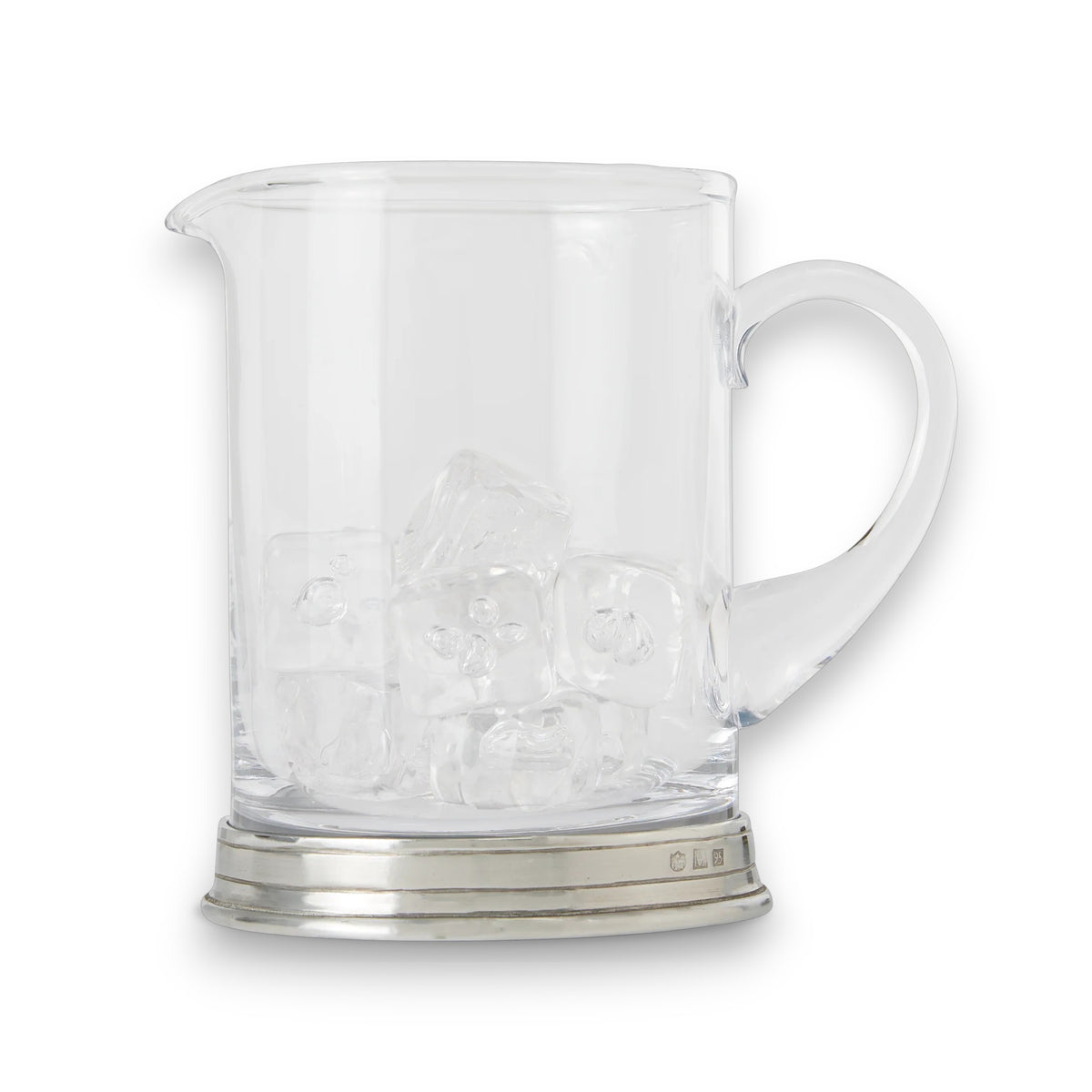 A table set with a martini glass holding an olive, a MATCH - BRANCH BAR PITCHER with a long spoon, a bottle of vodka, a bowl of nuts, a cheese plate, and red roses in the background.