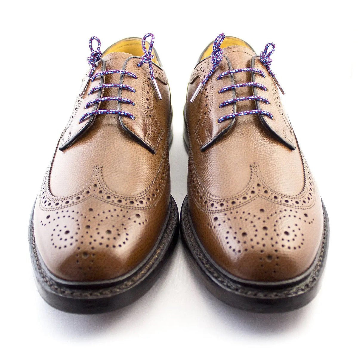 The STOLEN RICHES Dress Shoelace in Bavaria features a coiled blue, red, and white patterned premium nylon lace with silver tips and a branded white label—an eye-catching accessory for dress shoes.