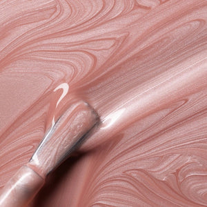 A bottle of MANUCURIST INC’s GREEN™ Nail Polish in the shade “Carnation,” featuring a black cap and pale pink color, with a label that reads “Quick Dry Intense Color.”.