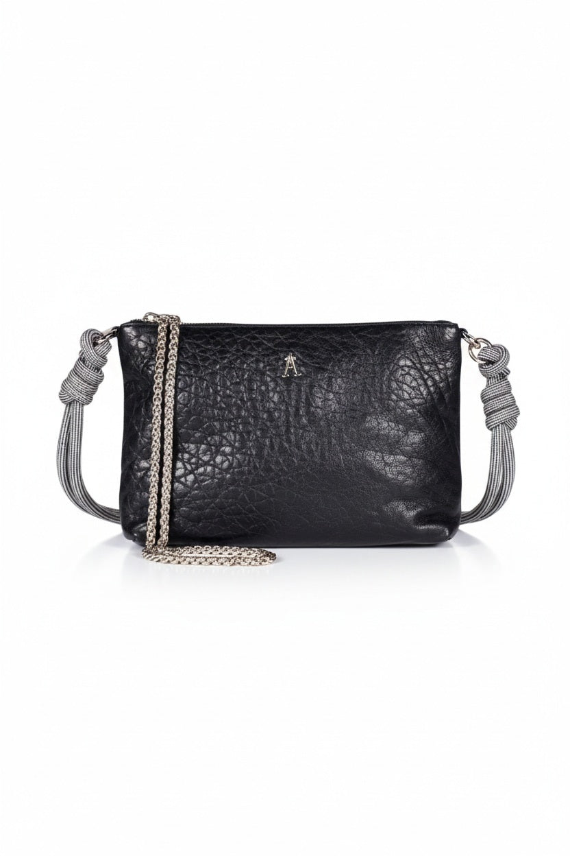 The CRAIE STUDIO - DUO BUBBLE NOIR HANDBAG by CRAIE STUDIO is showcased from above on a white background. This luxurious black bubble leather handbag features elegant gold zippers, two spacious compartments, and a gray corded strap. Crafted for both style and practicality, this chic double-zipped pouch perfectly balances fashion and function.