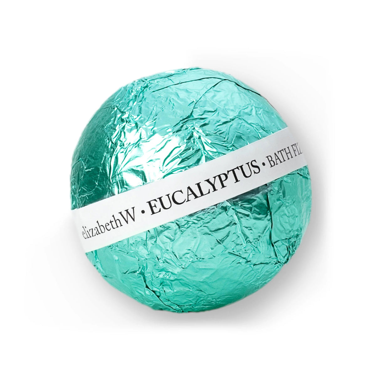 A round bath bomb wrapped in shiny teal foil with a white label that reads &quot;E WIGHTMAN &amp; CO · BATH FIZZ BALL EUCALYPTUS,&quot; offering the ultimate in nourishing fizz balls.