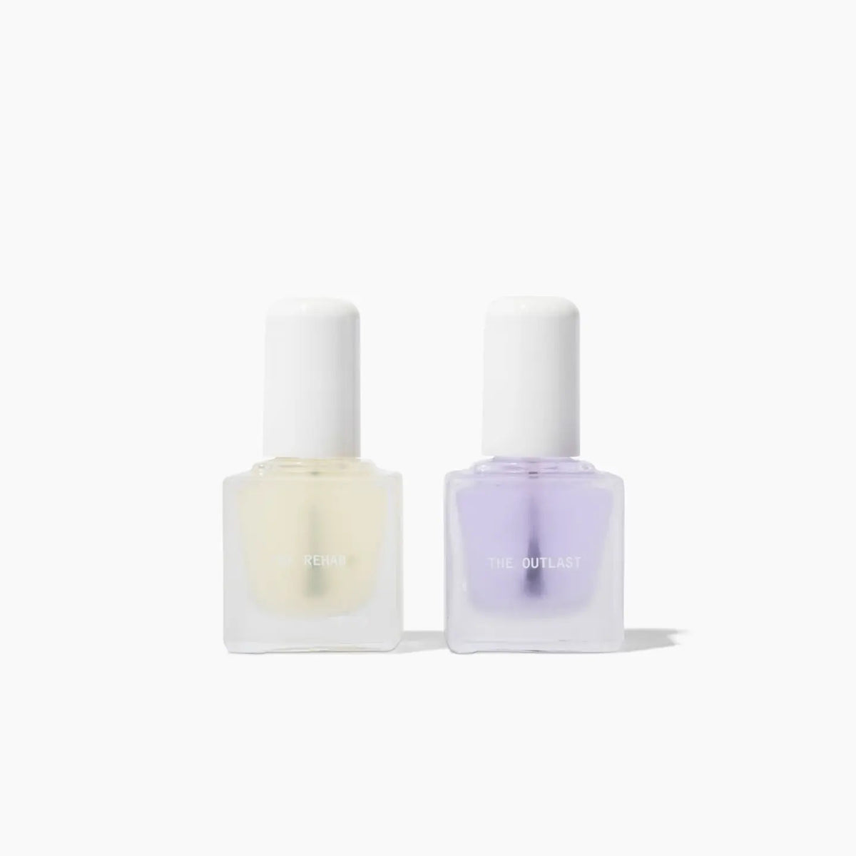 The TEN OVER TEN - THE REHAB TOP AND BASE COAT NAIL POLISH SET features two square glass bottles with white caps—one pale yellow (“REHAB” base coat) and one light purple (“THE OUTLAST” top coat)—side by side on a white background.
