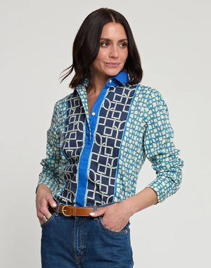 A person with shoulder-length dark hair is standing with their back to the camera, wearing a relaxed-fit HINSON WU - MARGOT LONG SLEEVE MAZE GEO PRINT SHIRT and blue jeans. The background is plain white.