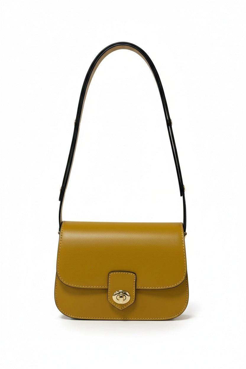 LEATHER HANDBAG IN MUSTARD by LE BORSETTE, a mustard yellow Italian leather shoulder bag with a structured silhouette, gold-tone turn-lock closure, and a black shoulder strap.