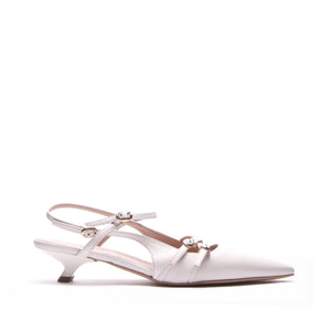 The MICHELE LOPRIORE - LUCILLE KITTEN HEEL is a sleek, modern slingback with a white pointed toe and low kitten heel. It features two buckled straps on a plain white background.