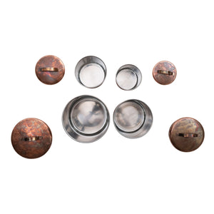 The CREATIVE COOP STAINLESS STEEL CANISTERS IN OXIDIZED COPPER FINISH, SET OF 4, feature simple metal handles and nest size by size—ideal farmhouse kitchen decor.