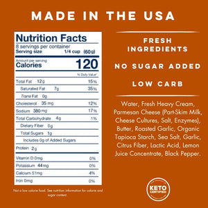 A jar of YO MAMA'S - ROASTED GARLIC ALFREDO by YO MAMA'S FOODS rests on an orange background, featuring a 16 oz (453g) label that boasts "Fresh Ingredients," "No Sugar Added," "Gluten-Free," with roasted garlic and parmesan cheese.
