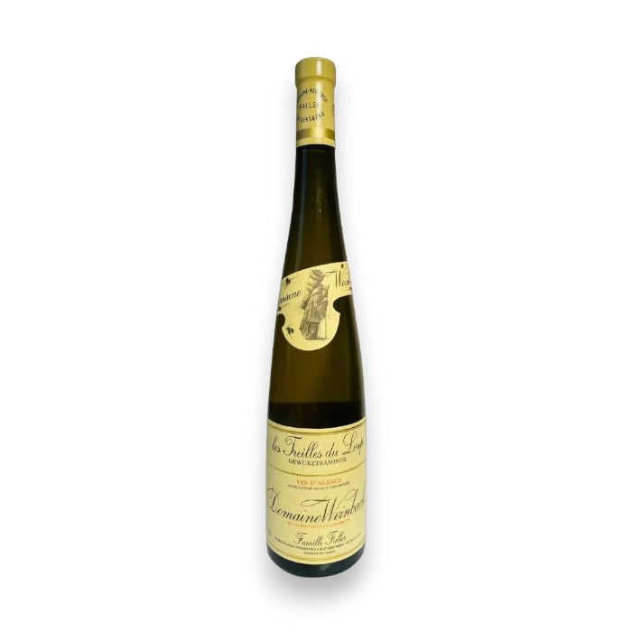 A tall, slender bottle of WEINBACH TREILLES DU LOUP GEWURZTRAMINER 2022 from WINE: JOHNSON BROS./MUTUAL/EPIPHANY stands upright against a white background, featuring a yellow label and gold foil on the neck.