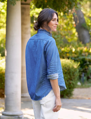 The FRANK & EILEEN Ruffle Eileen Relaxed Button Up in Vintage Stonewashed Denim has rolled-up long sleeves, a casual frayed collar, front pocket, button-down front, and slightly curved hem. The label reads "Frank & Eileen EST 1947.