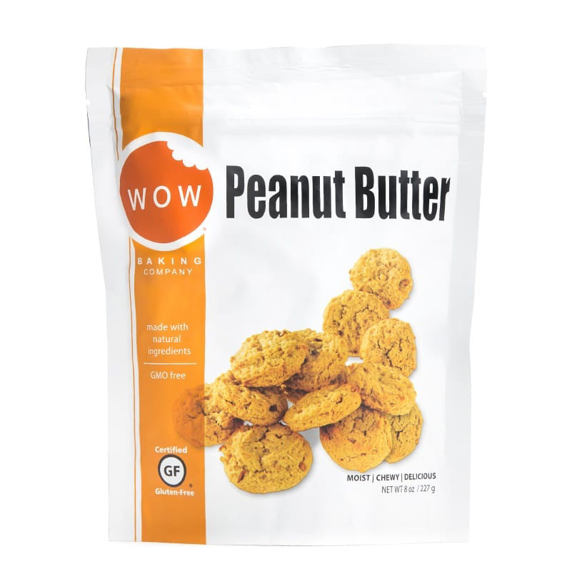 The packaging is white with an orange band on the left side, showcasing the &quot;WOW Baking Company&quot; logo. The label displays &quot;Peanut Butter&quot; and includes an image of gluten-free peanut butter cookies. It highlights that the product is “made with natural ingredients” and “gluten-free,” along with other relevant details.