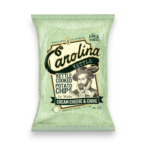 A green 5oz bag of CAROLINA KETTLE - CREAM CHEESE AND CHIVE CHIPS from 1 IN 6 SNACKS offers a gluten-free, savoury snack in every bite, with Sir Walter Raleigh holding a chip featured on the packaging.