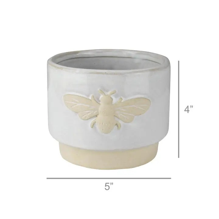 The HOMART CERAMIC BEE CACHEPOT is a charming 4" white ceramic planter with a beige base and a raised bee icon on the front.