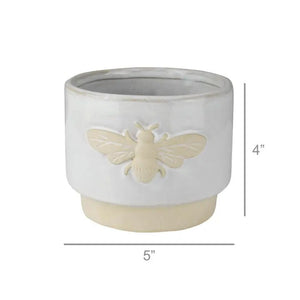 The HOMART CERAMIC BEE CACHEPOT is a charming 4" white ceramic planter with a beige base and a raised bee icon on the front.