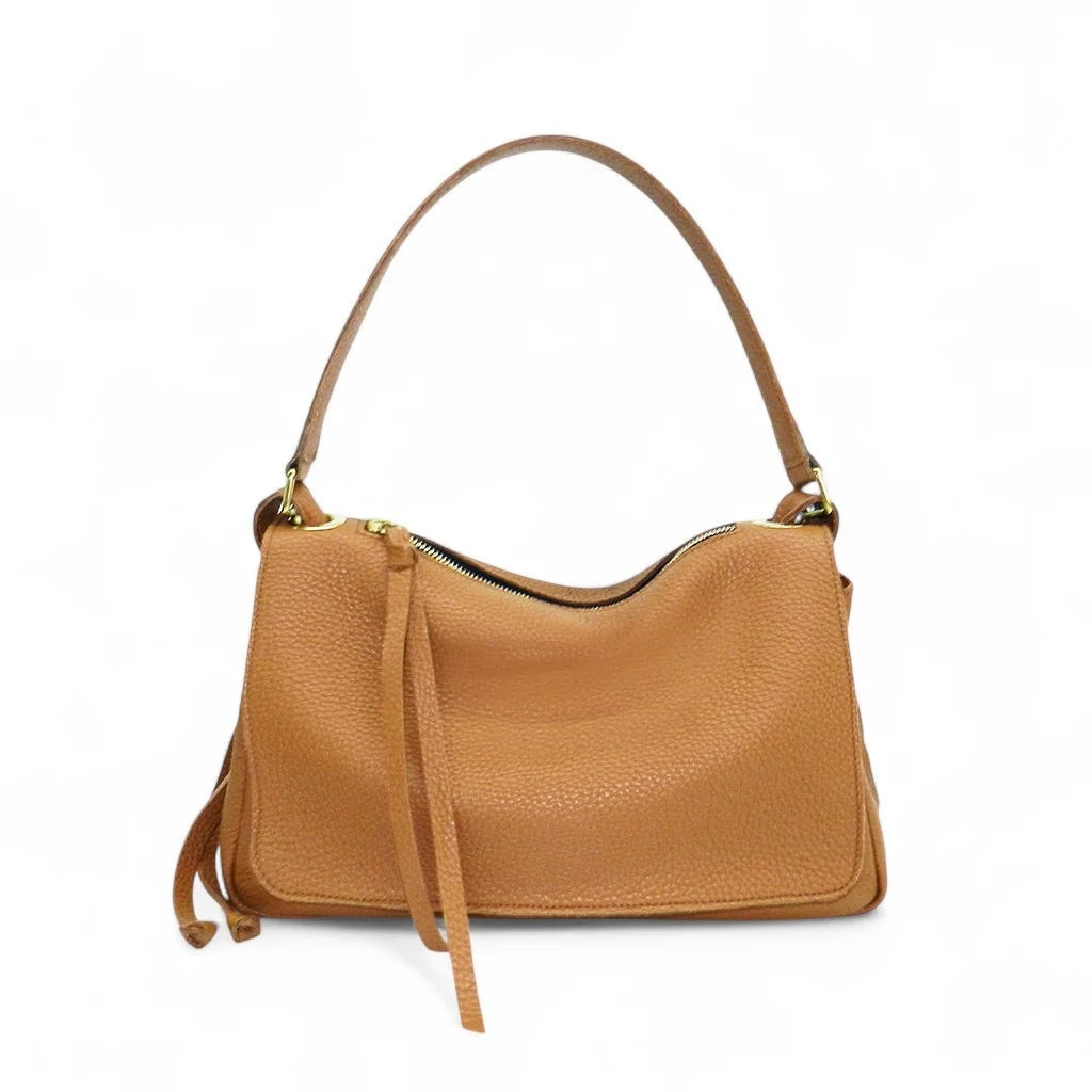 Side view of the OLIVEVE Remi Medium Slouchy Shoulder Bag in Miel Buffalo Cowhide, showcasing its luxurious Italian buffalo cowhide leather, single crossbody strap, visible drawstring, and textured surface against a plain white background.
