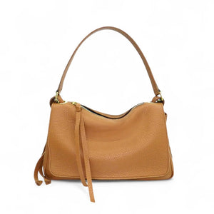 Side view of the OLIVEVE Remi Medium Slouchy Shoulder Bag in Miel Buffalo Cowhide, showcasing its luxurious Italian buffalo cowhide leather, single crossbody strap, visible drawstring, and textured surface against a plain white background.
