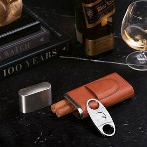 The BEYBERK INTERNATIONAL LEATHER CIGAR CASE holds three cigars, features a sleek cigar cutter in its front pocket, and comes with a separate metal lid for an elegant touch.