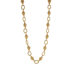 The CAPUCINE DE WULF - BERRY AND BEAD CHAIN NECKLACE 24" is a handmade piece featuring a gold chain with textured ovals and ornate, clustered links, evoking golden berries. Its luxurious and versatile design suits any occasion, beautifully showcased on a plain white background.