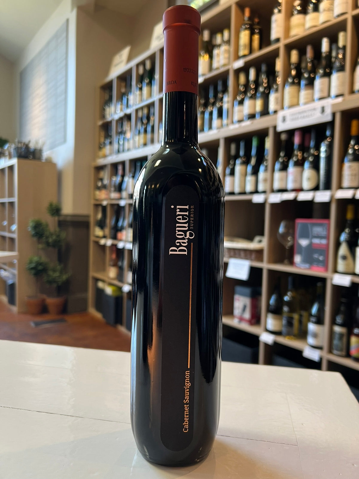 A tall, dark bottle of KLET BRDA 'BAGUERI' CABERNET SAUVIGNON 2019 by WINE: OCEAN SOUTH IMPORTS, featuring a copper foil top and vertical black label, photographed against a white background.