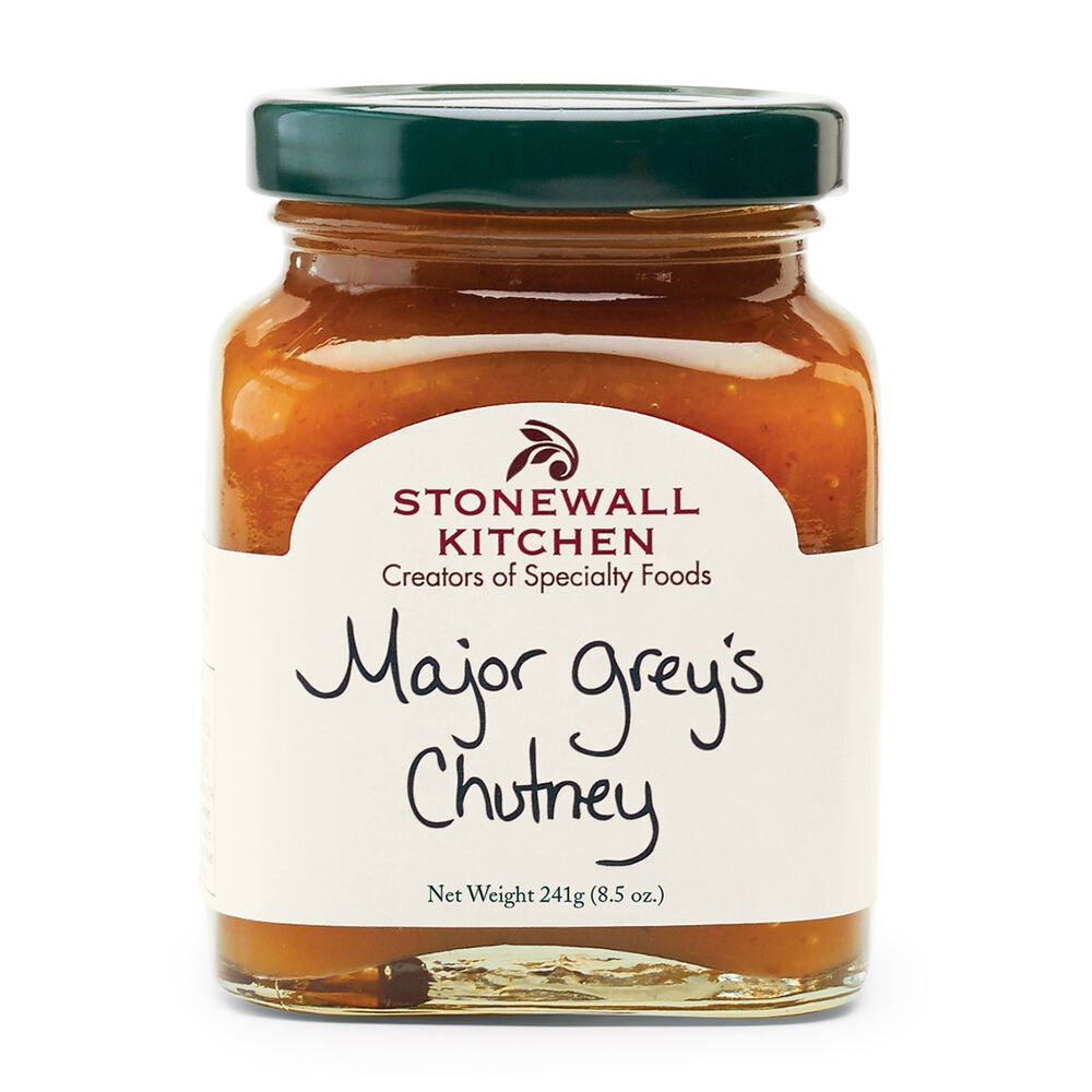 A clear jar with a green lid labeled “STONEWALL KITCHEN - MAJOR GREY’S CHUTNEY,” net weight 241g (8.5 oz.), filled with orange-brown chutney featuring the classic sweet and savory flavors of mango chutney.