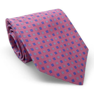 The BIRD DOG BAY PETER-BLAIR - BESPOKE SMALL SQUARES SILK TIE IN PINK is a handmade New York tie featuring a pink woven silk with repeating blue and purple squares on a white background.