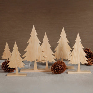 A ZODAX ASH WOOD SILHOUETTE TREE ON STAND 16″ featuring a flat ash wood cutout of a pine tree mounted on a rectangular wooden base.
