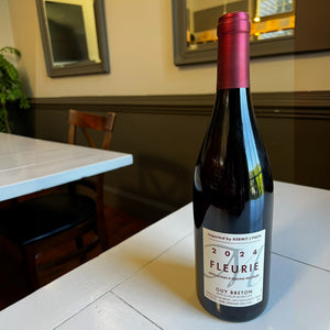 A bottle of GUY BRETON FLEURIE BEAUJOLAIS 2024 by WINE: TRYON, featuring a red foil top and white label with "Imported by Kermit Lynch," is shown against a white background.
