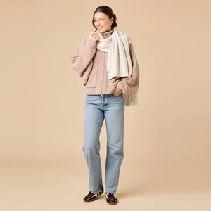 A dark navy blue SOFTIES - CABLE KNIT MARSHMALLOW SCARF draped in a loop.