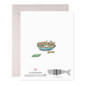 The E. FRANCES PAPER Dog Party Birthday Card is handcrafted with anthropomorphic dogs in party hats, featuring one with a cake and another with a gift. "Happy Birthday!" is highlighted in foil accents above them, while "Let's Party" appears below amidst balloons.