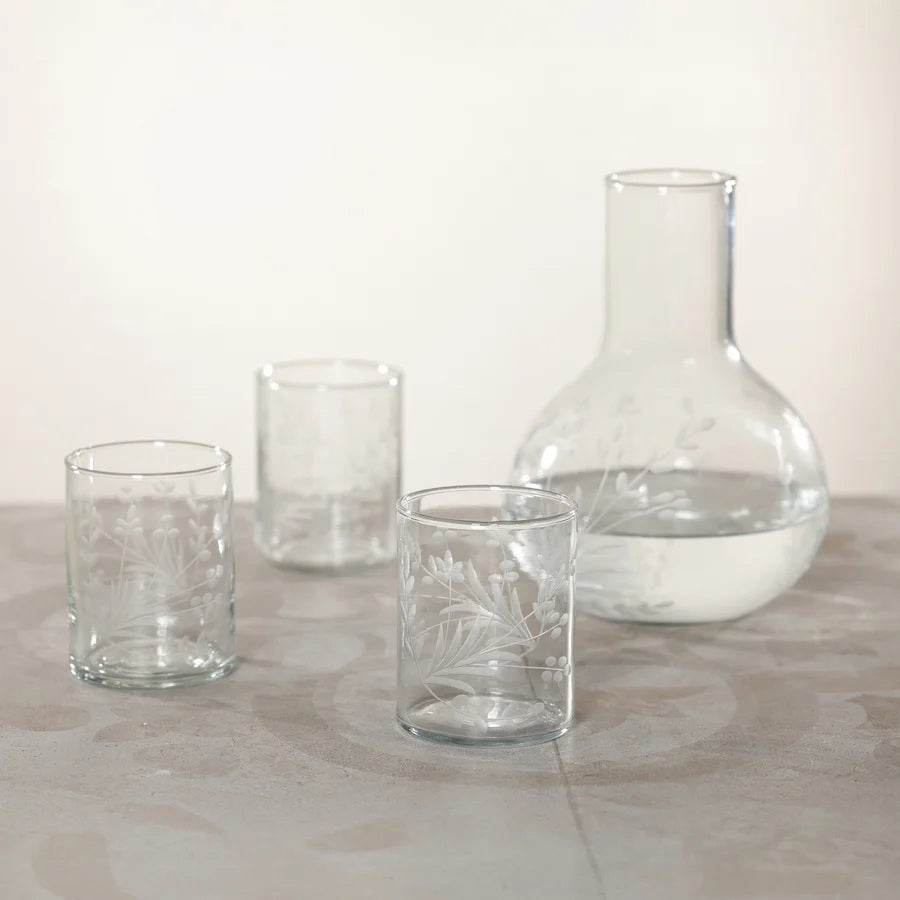 The ZODAX SHIRAZ TUMBLER features an etched flower design on its clear cylindrical surface, displayed against a plain white background.