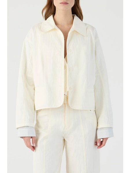A woman wears the ELEH Cotton Jacket with Inset Sleeve in off-white, featuring a wide collar, paired with matching pants. Her hands are at her sides against a plain white background.