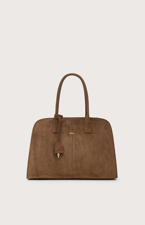 The SEVENTY VENEZIA suede leather bag in chocolate brown features two handles, a small padlock charm, and subtle gold branding on the front, displayed against a plain light background.