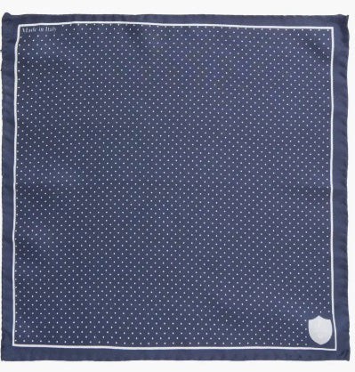 The CLIFTON WILSON - NAVY &amp; WHITE POLKA DOT SILK POCKET SQUARE features Italian silk in navy blue, a white dot grid pattern, a crisp white border, and a "CGW" crest in one corner.