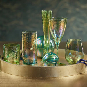 The ZODAX APERITIVO RED WINE GLASS - LUSTER GREEN is a textured 15 oz stemmed glass with a slightly flared bowl, shown against a white background.